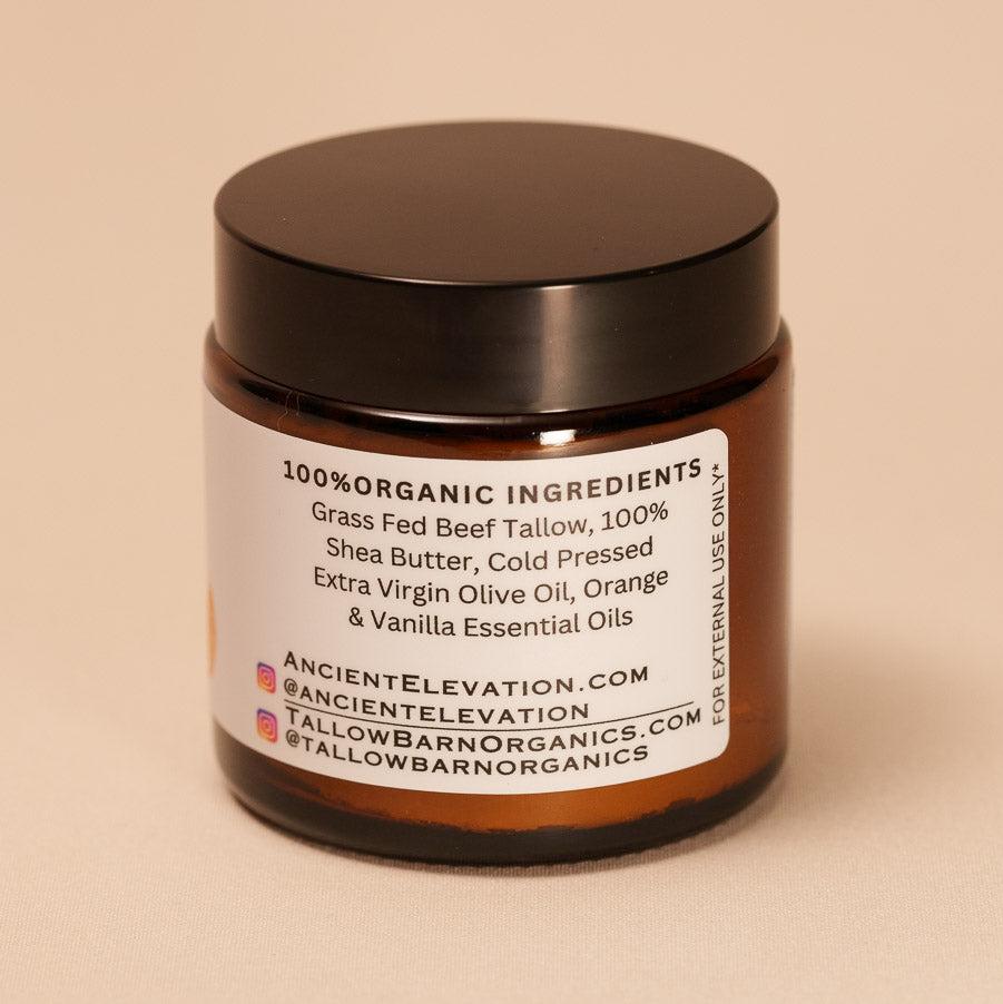 A jar of creamy whipped tallow balm with a simple label, showcasing its rich texture and natural ingredients, set against a soft, light backdrop.