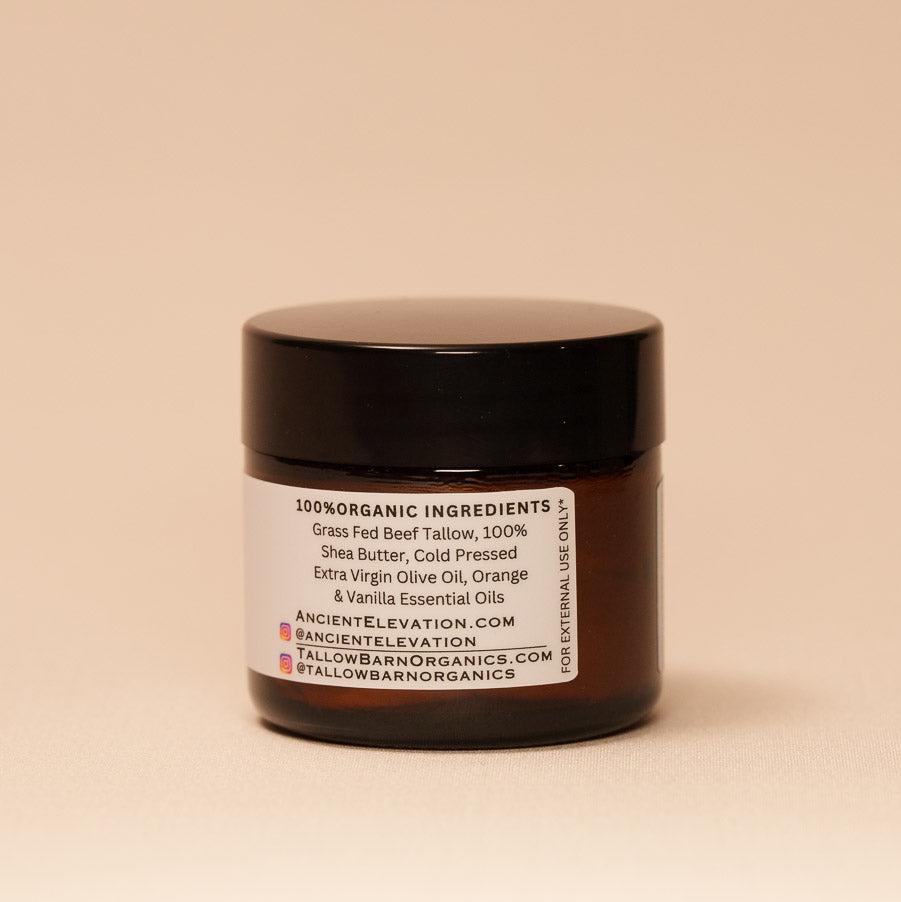 A jar of creamy whipped tallow balm with a simple label, showcasing its rich texture and natural ingredients, set against a soft, light backdrop.